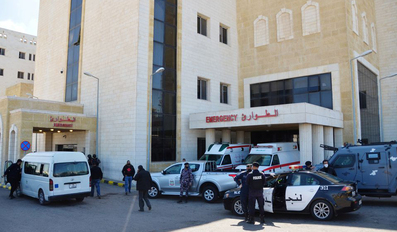 Police officers stand outside the new Salt government hospital